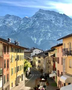 a city street with a mountain in the background at SecretGarden - Levico Terme in Levico Terme
