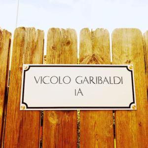 a sign on top of a wooden fence at SecretGarden - Levico Terme in Levico Terme