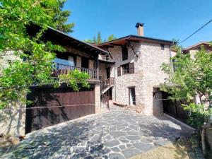 a large brick house with a gate and a driveway at Cal Ferrer del Querforadat in Cava