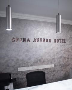 a sign that reads openena avenue hotel on a wall at Opera Avenue Hotel in Yerevan