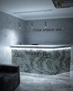 a lobby with a reception desk in a room at Opera Avenue Hotel in Yerevan