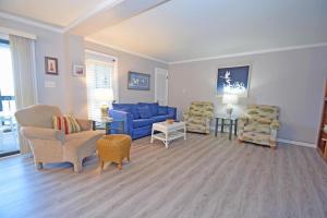a living room with a blue couch and chairs at Our Place At The Beach 105E Condo in Ocean City