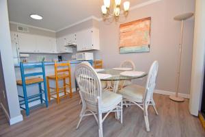 a dining room with a table and chairs and a kitchen at Our Place At The Beach 105E Condo in Ocean City +9 photos