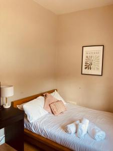 a bedroom with a bed with two pillows on it at 'Bloomfield' at stayBOOM in Lancaster