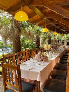 a long table in a restaurant with yellow lights at PalmaNova Resort in Tirana