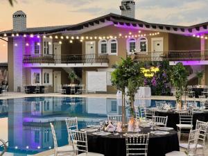 a wedding reception in front of the swimming pool at a resort at PalmaNova Resort in Tirana