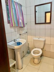 a bathroom with a toilet and a sink at Queen Zee Garden Apartments in Kololi