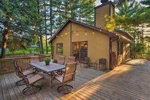 a house with a table and chairs on a deck at Lake Geneva Getaway with Fire Pit Near Golf in Lake Geneva