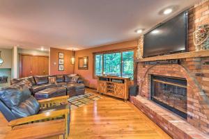 a living room with a couch and a fireplace at Lake Geneva Getaway with Fire Pit Near Golf in Lake Geneva