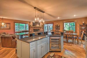 a large kitchen with an island in the middle of a room at Lake Geneva Getaway with Fire Pit Near Golf in Lake Geneva