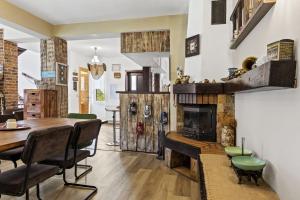 a dining room with a table and a fireplace at Casa Georgea in Săcele
