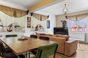 a living room with a table and a couch at Casa Georgea in Săcele