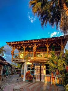 a wooden building with a balcony on top of it at Eco Hotel las Palmas in Armenia