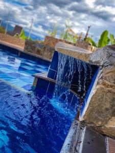 uma piscina de mergulho com água azul a sair dela em Eco Hotel las Palmas em Armênia