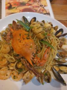 a plate of pasta with shrimp and mussels at Cabinas Carolina in Puerto Jiménez