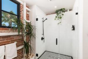 a bathroom with a shower with plants in it at The Brick Boutique Hotel in Oceanside