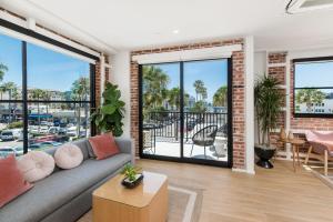 a living room with a couch and a view of a marina at The Brick Boutique Hotel in Oceanside