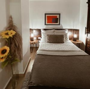 a bedroom with a bed and a vase of flowers at Studio 27 in Santo Domingo +69 photos