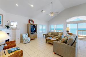 a living room with a couch and a tv at Beach Boy in St. George Island