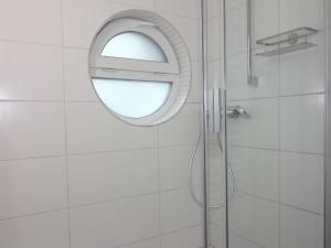 a bathroom with a mirror and a shower at Chalet in Wendorf in Wendorf