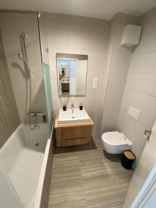 a bathroom with a sink and a toilet and a shower at Premium Lelle Waterfront Resort Clyde in Balatonlelle