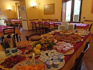 a long table filled with different types of food at La Terra Del Mezzo in Riposto