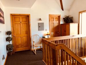 a room with a staircase and a wooden door at Susitna River Lodging, Suites in Talkeetna