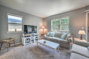 a living room with a couch and a table at Harbor Springs Retreat with Grill about 1 Mi to Beach! in Harbor Springs