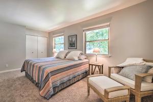 a bedroom with a bed and a chair at Harbor Springs Retreat with Grill about 1 Mi to Beach! in Harbor Springs