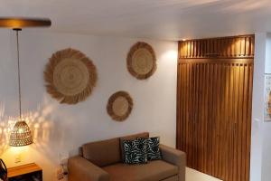 a living room with a couch and some decorations on the wall at Estudio acogedor con vista al mar in Nuevo Vallarta
