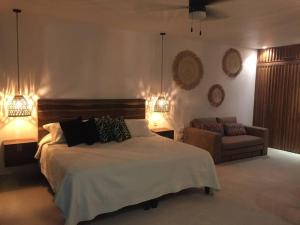 a bedroom with a bed and a couch and lights at Estudio acogedor con vista al mar in Nuevo Vallarta