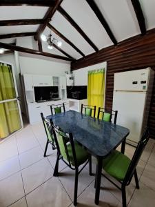 a dining room with a black table and chairs at CABAÑAS EL CERRO in Ciudad Lujan de Cuyo