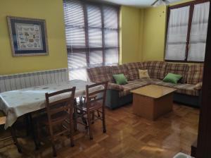a living room with a table and a couch at Apartamento Parque Europa in Ezcaray +25 photos