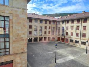 an empty courtyard of a large brick building at Apartamento Parque Europa in Ezcaray