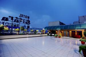 a building with a lit up courtyard at night at Sitara Paradise in Hyderabad