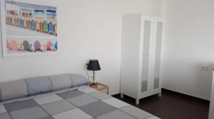 a bedroom with a bed and a picture on the wall at Alojamiento Rural El Abuelo in Conil de la Frontera