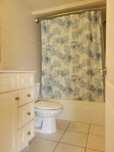 a bathroom with a toilet and a shower curtain at Sunbeach Condo 900 Wesley Avenue Unit 109 in Ocean City