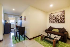 a living room with a couch and a table at Kanokkan Apartment in Hua Hin