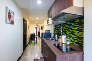 a kitchen with a sink and a counter top at Kanokkan Apartment in Hua Hin