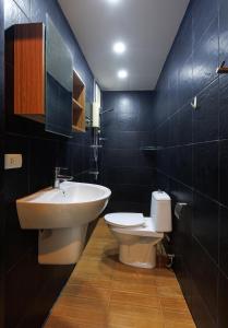 a bathroom with a sink and a toilet in it at Kanokkan Apartment in Hua Hin