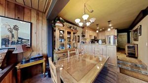 a kitchen with a large wooden table in a room at Lakeview 826 Condo #532 Condo in Mammoth Lakes