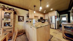 a kitchen with wooden cabinets and a refrigerator at Lakeview 826 Condo #532 Condo in Mammoth Lakes +38 photos