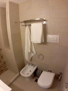 a bathroom with a sink and a toilet and towels at Alumine in Puerto Madryn +32 photos