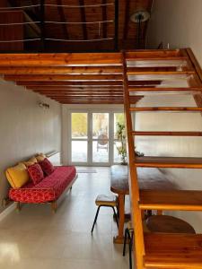 a living room with a staircase and a couch at Casa cálida súper confortable hasta 7 personas in Esquel