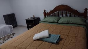 a bedroom with a bed with a towel on it at Tan Ushuaia in Ushuaia