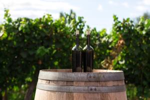 two bottles of wine sitting on top of a barrel at 703 Cottages at Silverado residence in Napa