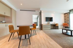 a living room with a table and chairs at Bridges Villas Barooga in Barooga