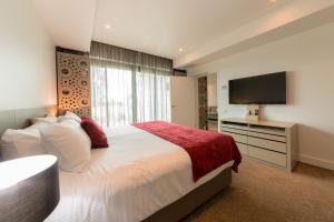 a hotel room with a large bed and a large window at Bridges Villas Barooga in Barooga