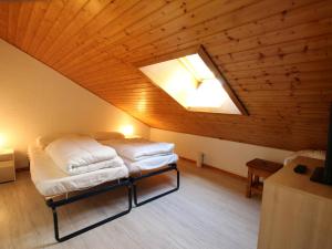 a bedroom with a bed in a attic with a skylight at Studio Les Carroz d'Arâches, 1 pièce, 4 personnes - FR-1-572-60 in Arâches-la-Frasse