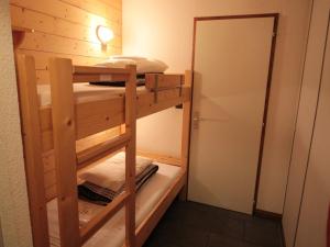 a bunk bed room with two bunk beds and a mirror at Appartement Les Carroz d'Arâches, 2 pièces, 4 personnes - FR-1-572-87 in Arâches-la-Frasse
